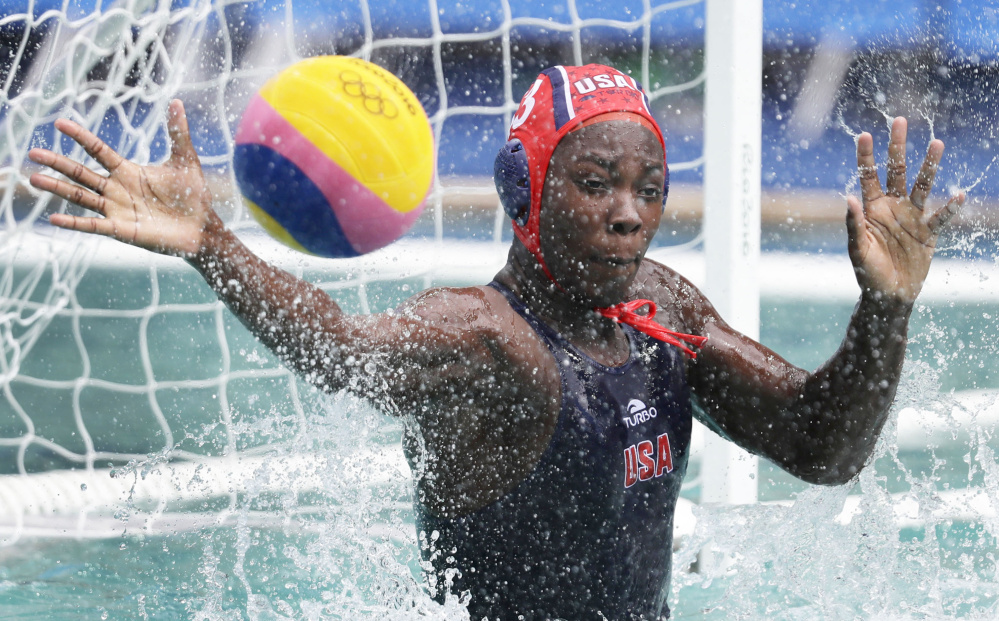 Ashleigh Johnson of the United States attempts to stop the ball Thursday during the 12-4 victory against China in women's water polo. Including the Olympics, the U.S. has an 18-game winning streak.