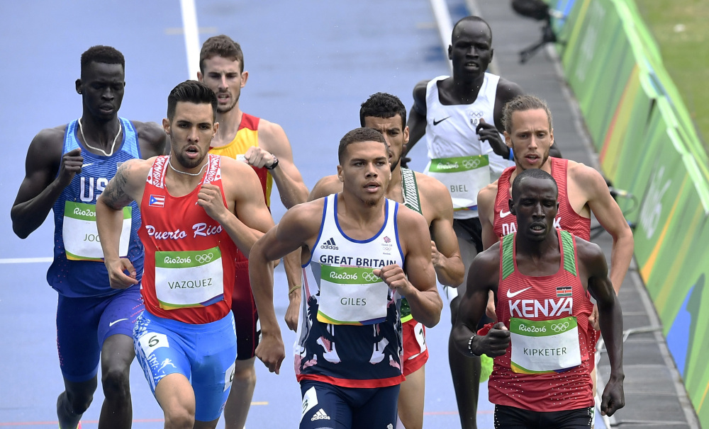 Yiech Pur Biel of the Refugee Olympic Team, rear right, runs at the back of the field in a men's 800-meter heat during the athletics competitions of the 2016 Summer Olympics at the Olympic stadium in Rio de Janeiro, Brazil, Friday, Aug. 12, 2016.