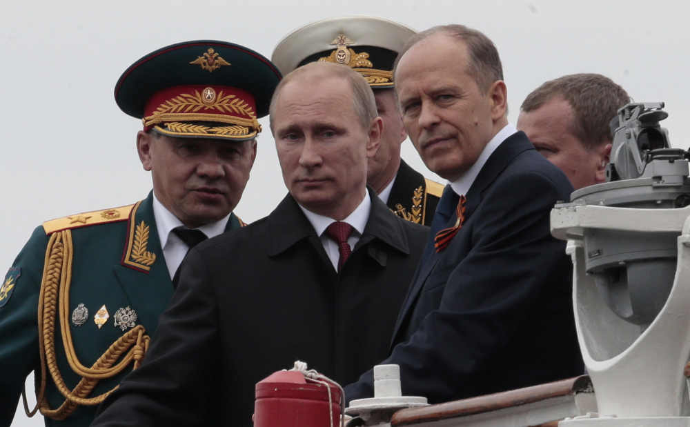 Vladimir Putin, center, seen in 2014, this week accused Ukraine of plotting attacks in Crimea. With the U.S. and Europe distracted, this may be an opportunity for Russia to escalate war without fear of a serious response.