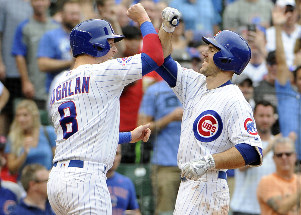 Chicago's Matt Szczur, right, is greeted by Chris Coghlan after hitting a two-run homer against the St. Louis Cardinals during the seventh inning of Chicago's 13-2 victory on Friday.