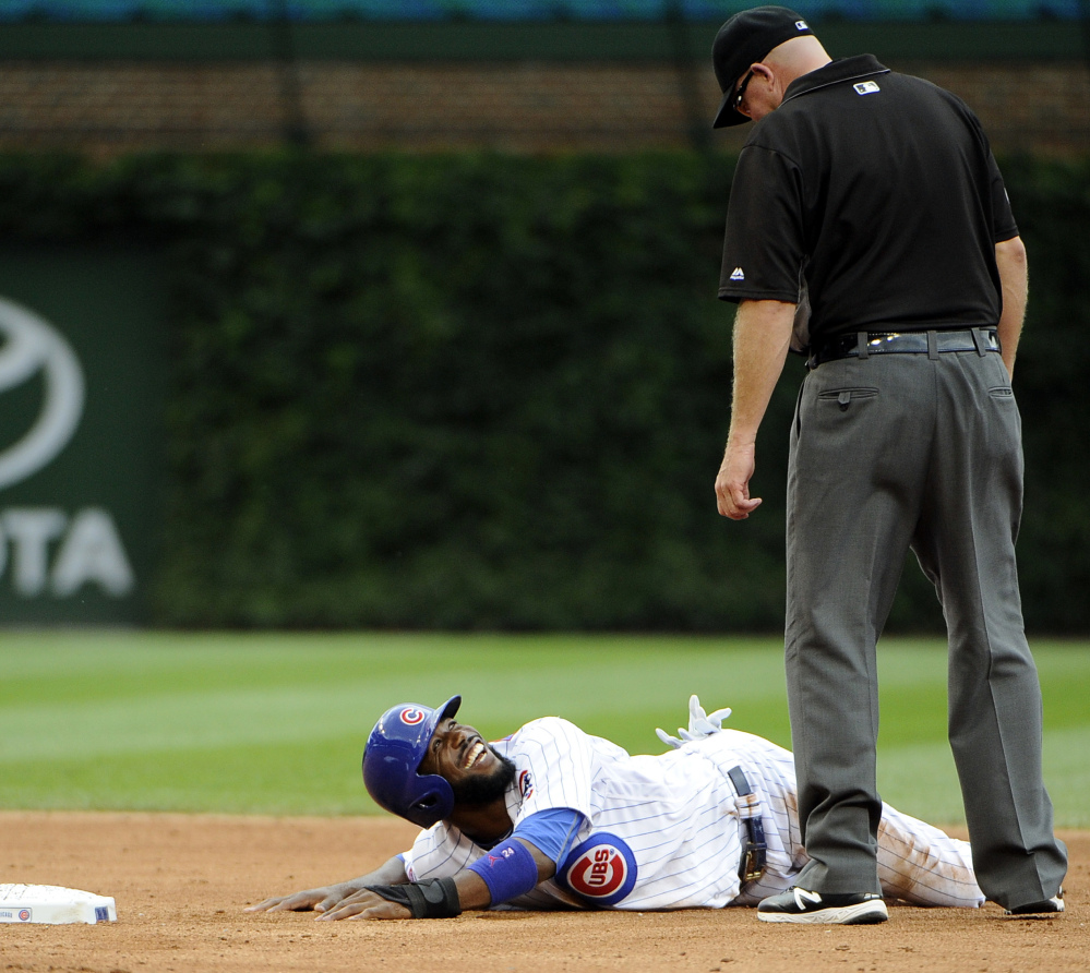 Dexter Fowler of the Chicago Cubs looks up at umpire Ron Kulpa after being called out trying to steal second Saturday during an 8-4 loss to St. Louis.