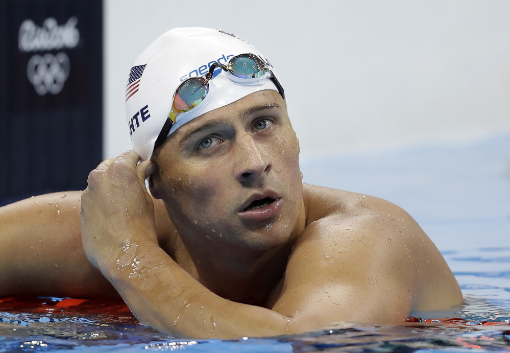 Ryan Lochte and three other American swimmers were robbed at gunpoint early Sunday by thieves posing as police officers, the U.S. Olympic Committee says.