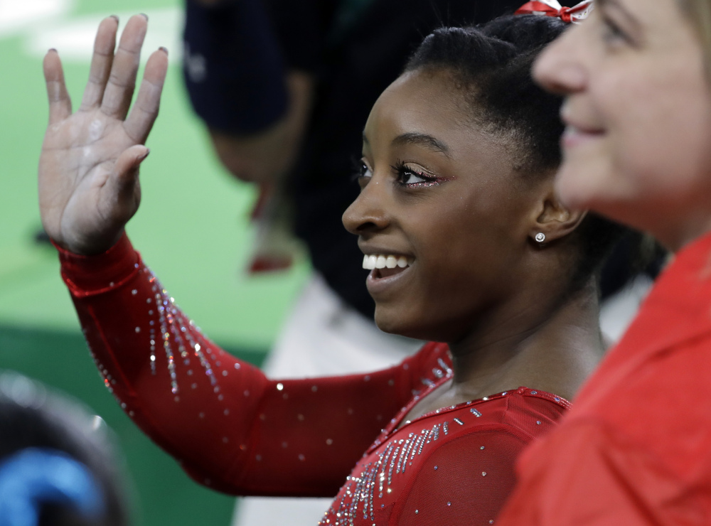 United States' Simone Biles waves to the audience after performing on the vault during the artistic gymnastics women's apparatus final Sunday at the 2016 Summer Olympics in Rio de Janeiro.
