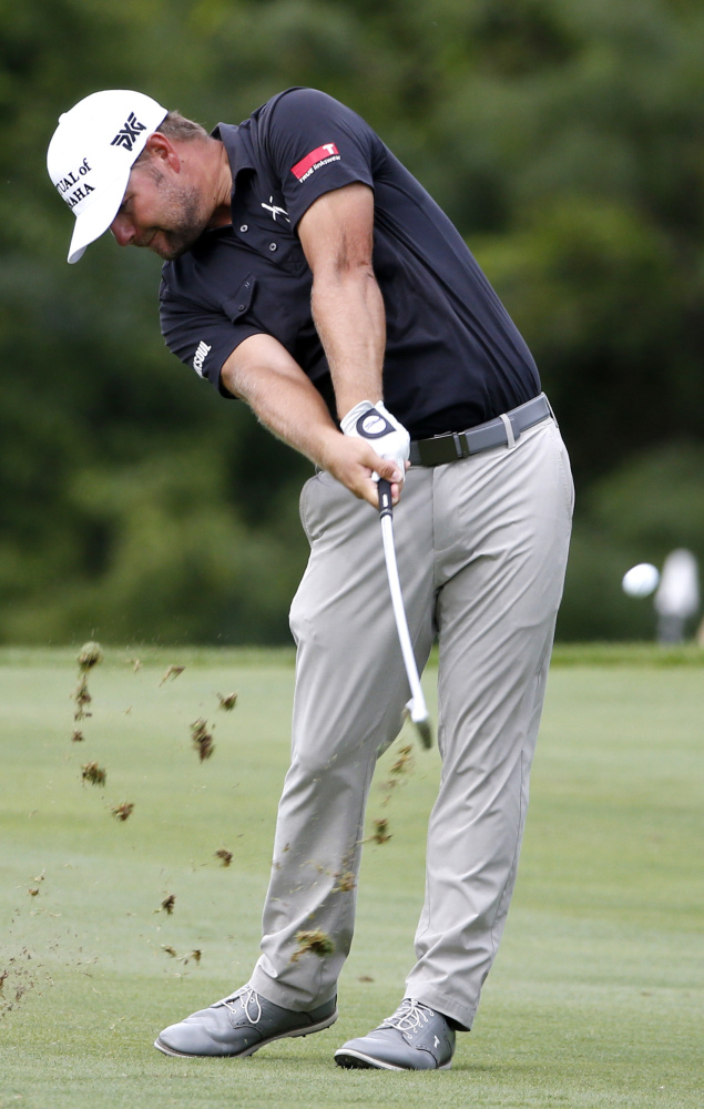 Ryan Moore hits from the 15th fairway during the final round of the John Deere Classic in Silvis, Ill. Moore won the tournament by two strokes over Ben Martin.