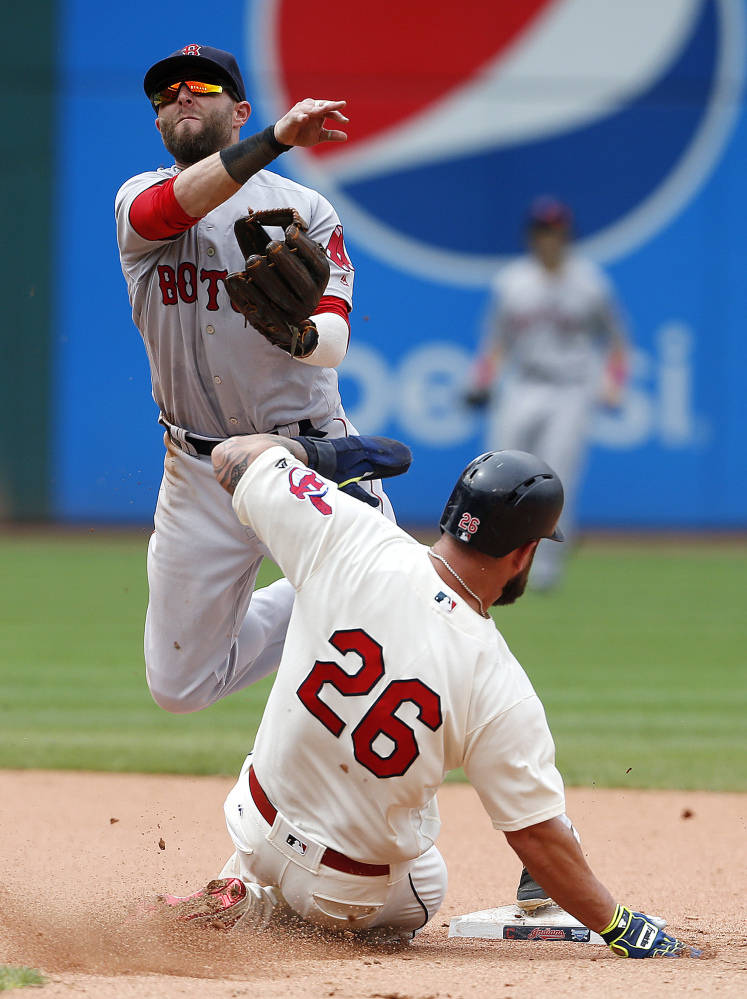 Boston's Dustin Pedroia forces out Cleveland's Mike Napoli at second base and throws out Carlos Santana at first base to complete the double play in the seventh inning Monday in Cleveland.