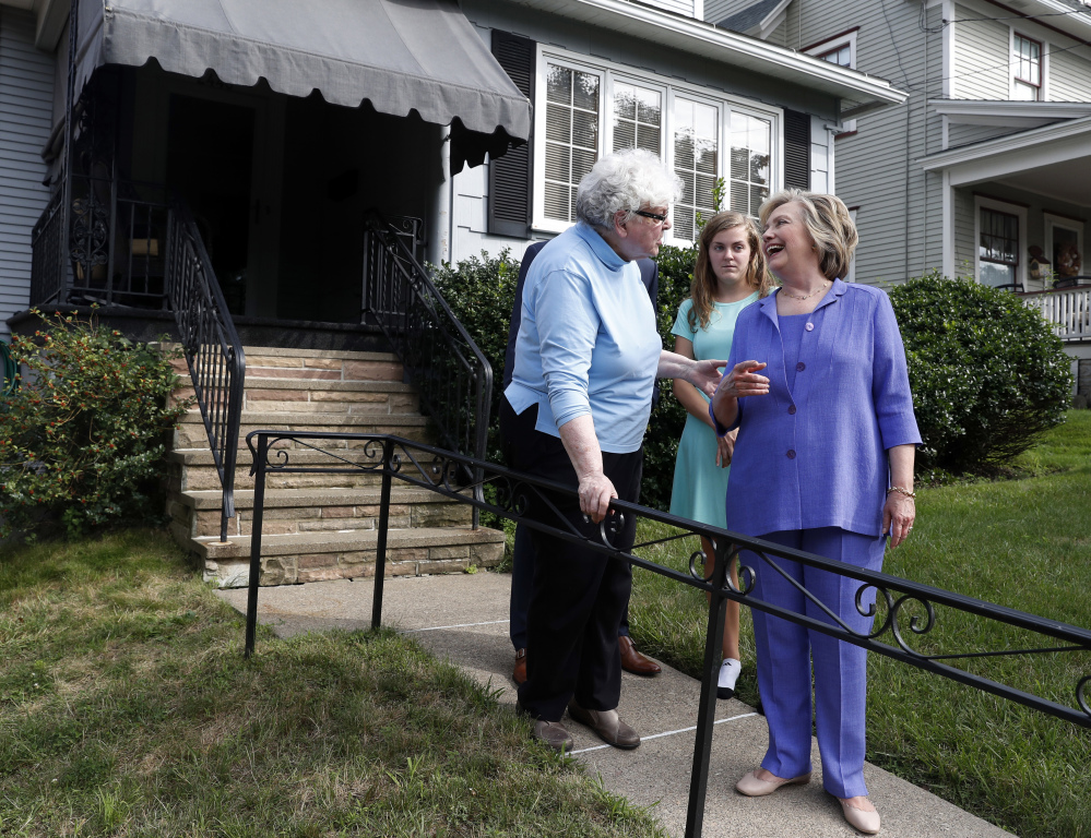 Democratic presidential candidate Hillary Clinton talks with Anne Kearns, left, as she and Vice President Joe Biden visit Biden's childhood home in Scranton, Pa., on Monday.
