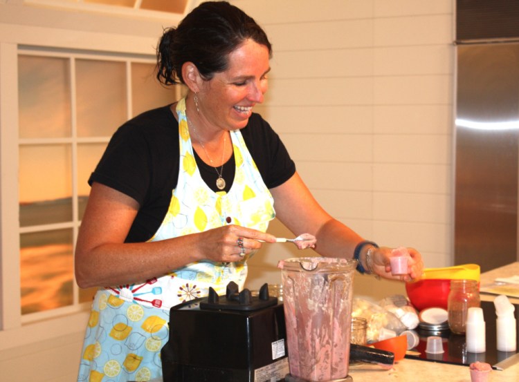 Elizabeth Fraser, who runs the Girl Gone Raw Cooking School, demonstrates how to make strawberry nice cream during the event.