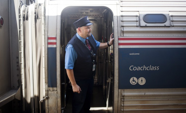 Chuck Moyer, a conductor who has been with Amtrak for 27 years, looks out along the train at the Brunswick stop Friday. The Amtrak Downeaster's  $9.3 million Royal Junction Siding project is expected to begin next year.