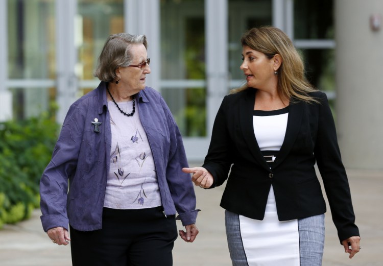 Angela McArthur, right, director of the Anatomy Bequest Program at the University of Minnesota Medical School, walks with Jean Larson, widow of a donor in Minneapolis. Jean Larson plans to donate her body, too: "This is the most generous donation we can make."