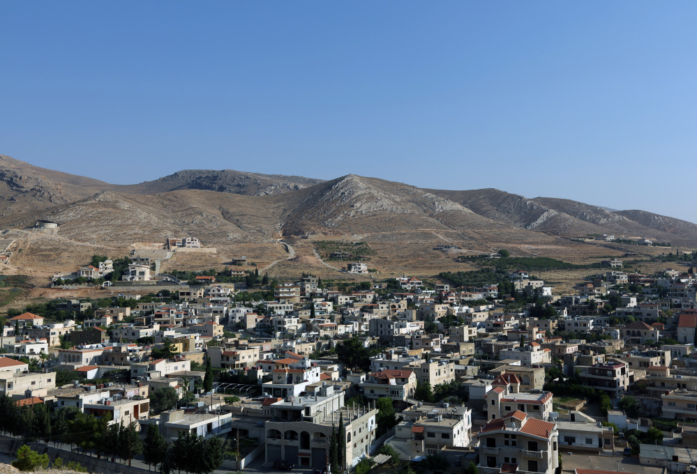 This Wednesday, Aug. 13, 2014 photo, shows a general view of Lebanon's Ras Baalbek, a Christian town in the northern Bekaa region near the border with Syria. Across the Middle East, Christian communities as old as the religion itself feel their very survival is at stake, threatened by militants of the Islamic State group rampaging across Iraq and Syria. Many Christian villagers are setting up self-defense units to protect themselves against attack. In Qaa and Ras Baalbek, two Christian northeastern villages on the border with Syria, many of the thousands of expatriates who used to spend the summer there stayed away this year. (AP Photo/Bilal Hussein)
