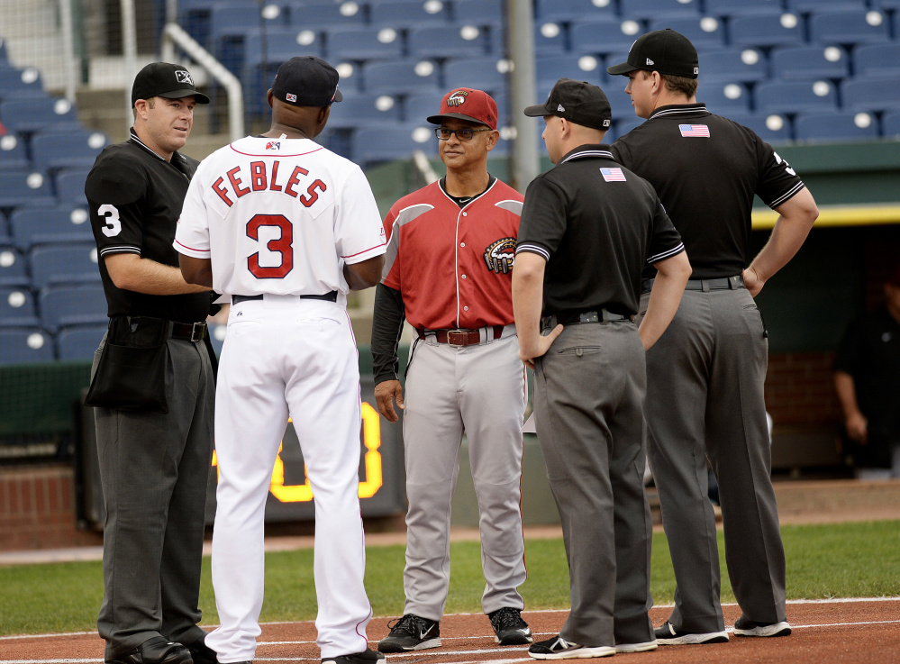 PORTLAND, ME - AUGUST 16: Portland Sea Dogs manager Carlos Febles talks with Altoona's manager Joey Cora along with umpires prior to Tuesday's game, August 16, 2016. (Photo by Shawn Patrick Ouellette/Staff Photographer)