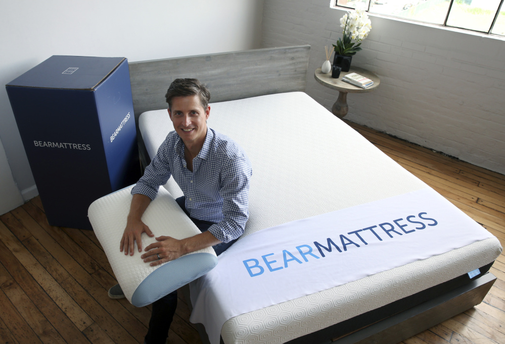 Scott Paladini, CEO of Bear Mattress, sitting with a Bear Mattress, pillow and shipping box in Hoboken, N.J.,  says 85 percent of the company's online visitors are using mobile devices.