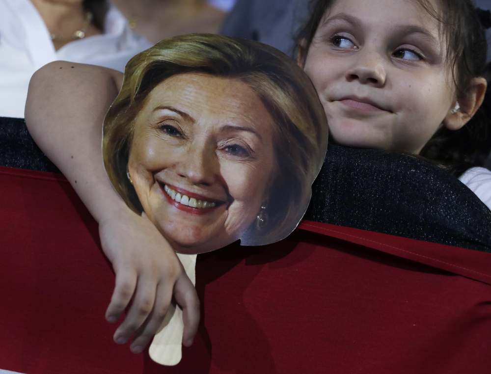 Hunter Lassus, 7, of Seven Hills, Ohio, holds an image of Democratic presidential nominee Hillary Clinton during a campaign event in Cleveland on Wednesday.