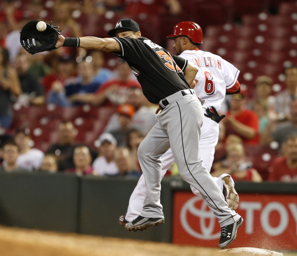 Cincinnati's Billy Hamilton beats the throw to Marlins first baseman Derek Dietrich for a single, setting up the Reds' seventh-inning rally in a 3-2 win.