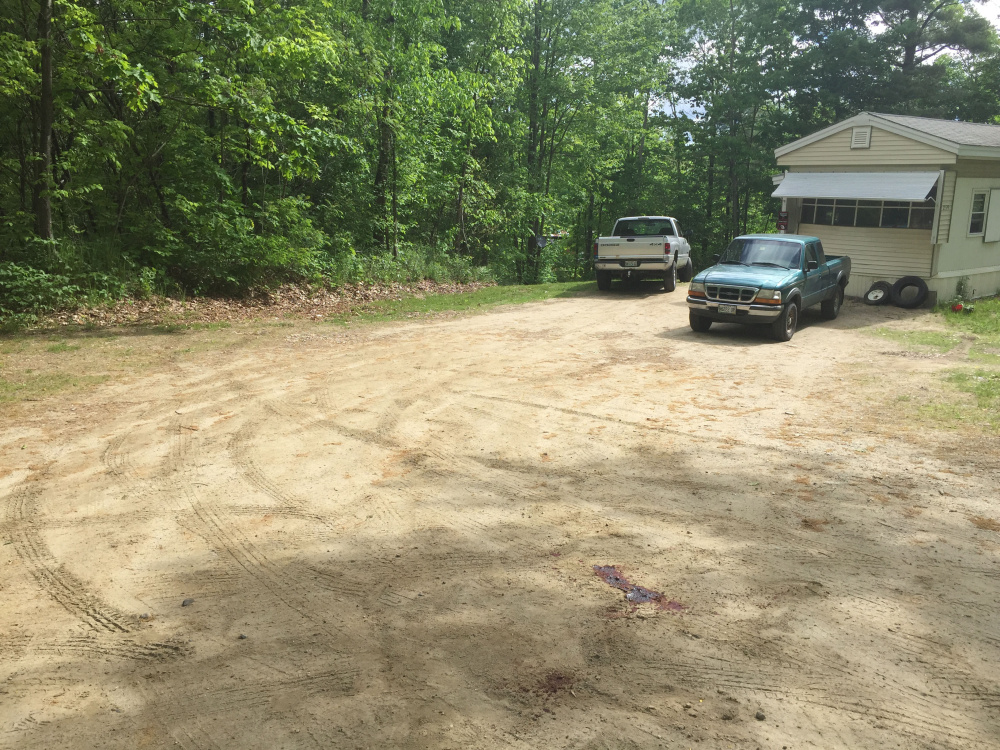 Blood pools on June 1 in the driveway at 259 Weld Road in Wilton, where police were investigating the shooting death of Michael Reis of New Sharon. Timothy Danforth, a resident of the home, was arrested Thursday and charged in the killing.