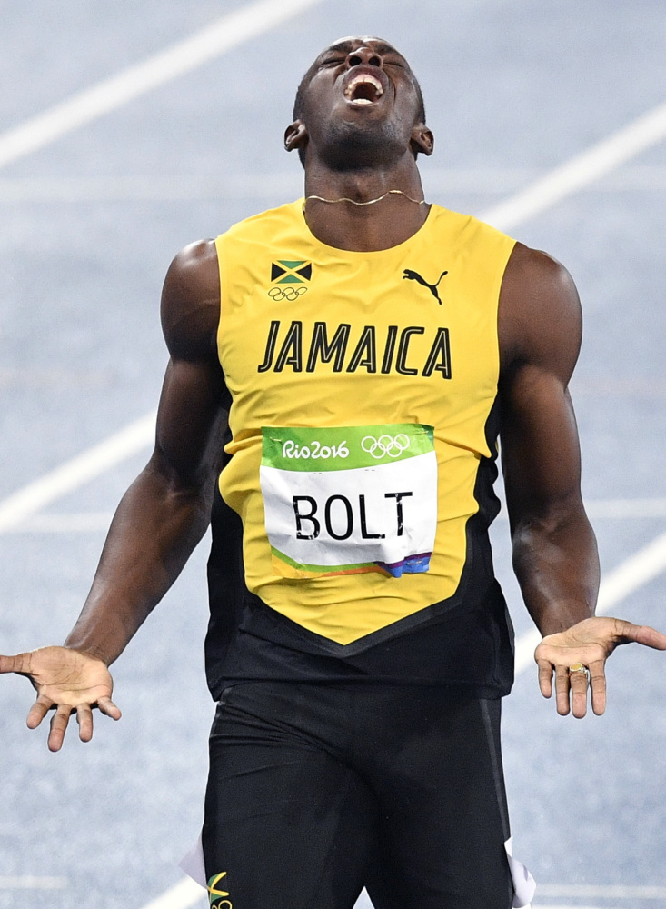Usain Bolt of Jamaica won his third straight gold medal Thursday night in his favorite event – the 200 meters – but gave a painful reaction at the finish line, realizing he failed to break his own world record.