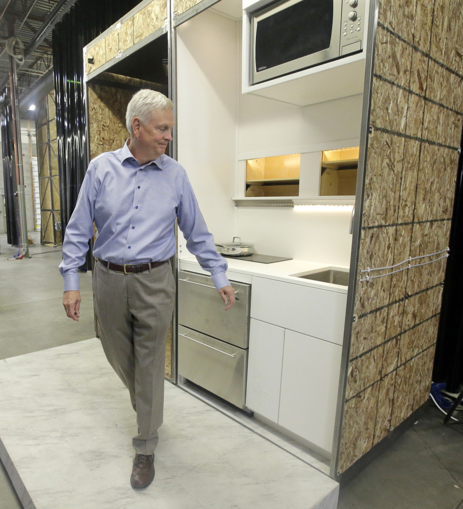 David Hall checks out a kitchen for a new type of modular residential structure Friday at a warehouse in Provo, Utah. Hall, a Mormon businessman, has an ambitious plan to create communities in Utah and Vermont of small, environmentally sustainable dwellings based on the teachings of church founder Joseph Smith.