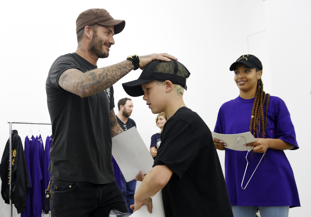 David Beckham and his son Cruz shop together at Kanye West's pop-up shop on Friday in Los Angeles.