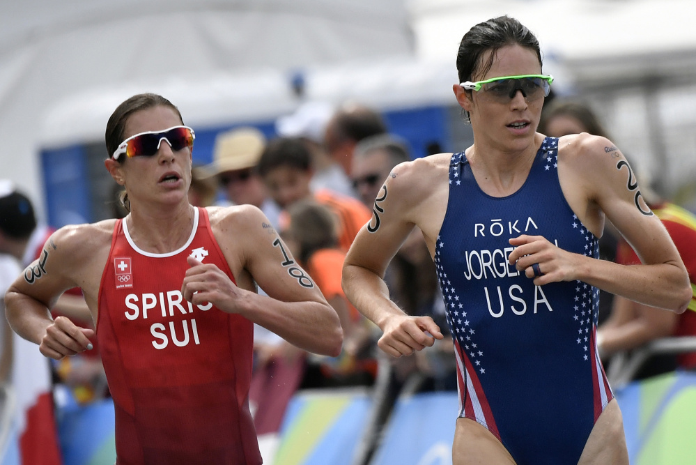 Gwen Jorgensen, right, of the U.S. and defending Olympic champion Nicola Spirig of Switzerland run side-by-side during Saturday's triathlon. Jorgensen pulled away in the final mile to win the gold medal.