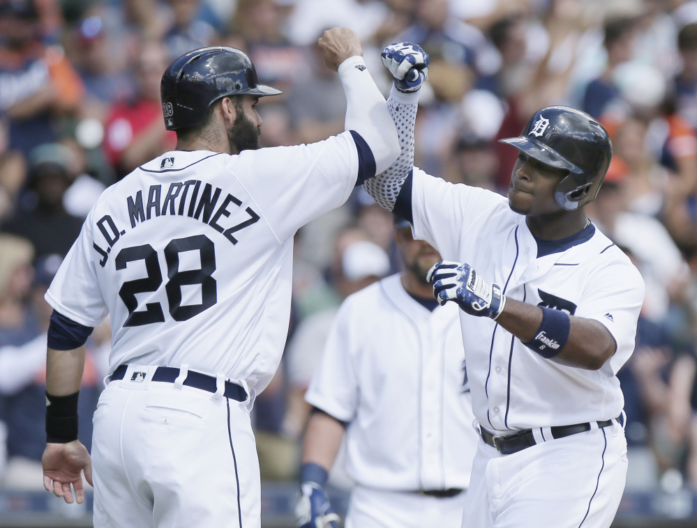 Tigers' Justin Upton, right, celebrates with J.D. Martinez after hitting a three-run homer against the Boston Red Sox during the third inning Sunday in Detroit.