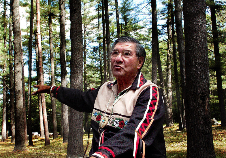 Penobscot tribe elder Butch Phillips speaks prior to a ceremony honoring ancestors Sunday in The Pines area off Father Rasle Road in Madison, where Native Americans were massacred in 1724.