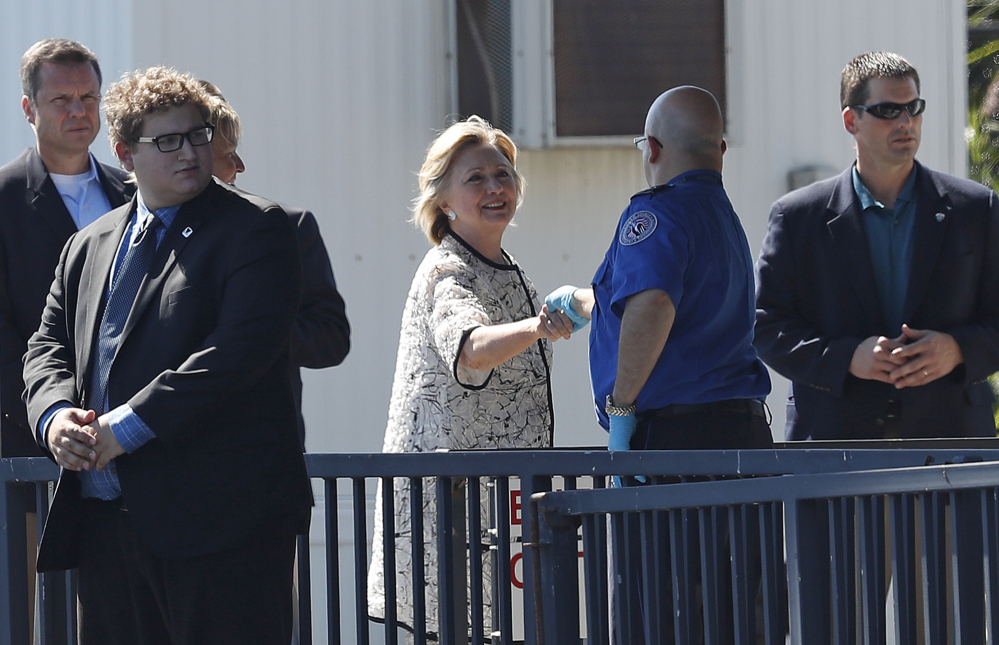 Democratic presidential candidate Hillary Clinton greets people as she arrives at Provincetown Municipal Airport in Provincetown, Mass., Sunday.