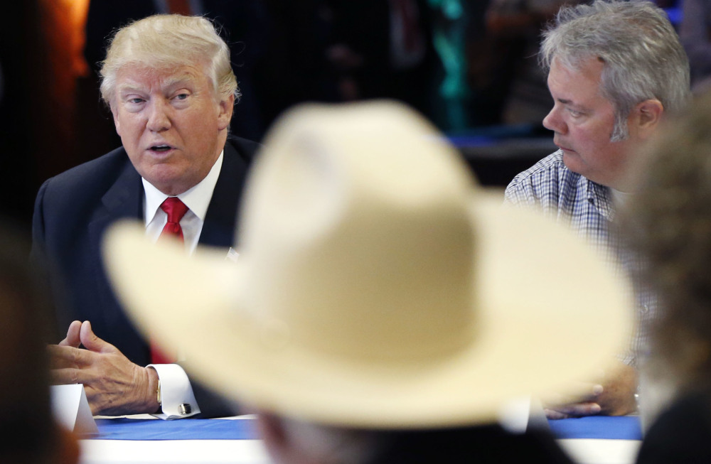Republican presidential candidate Donald Trump meets with active and retired members of law enforcement Monday. Trump said Monday he is "working with a lot of people in the Hispanic community to try and come up with an answer" on illegal immigration.
