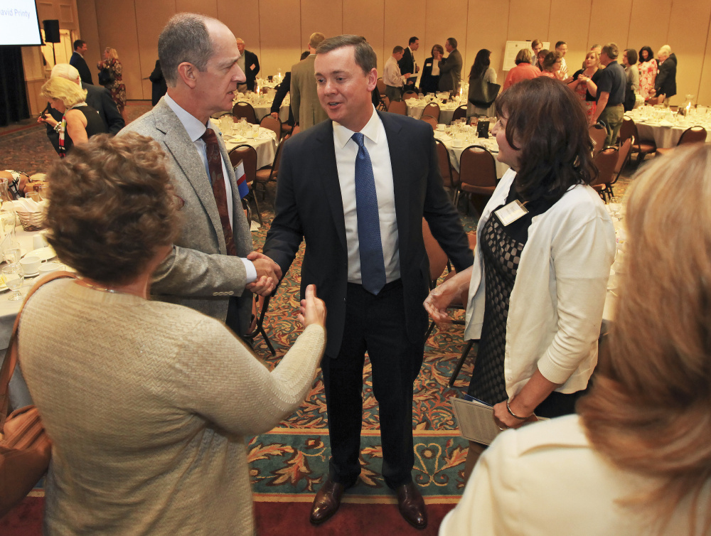 Chris Cox, executive director of the NRA Institute for Legislative Action, greets Robert Tracy, left, of South Portland, and others after speaking at the 2016 Freedom & Opportunity Luncheon put on by the Maine Heritage Policy Center at the Holiday Inn By the Bay in Portland on Wednesday.