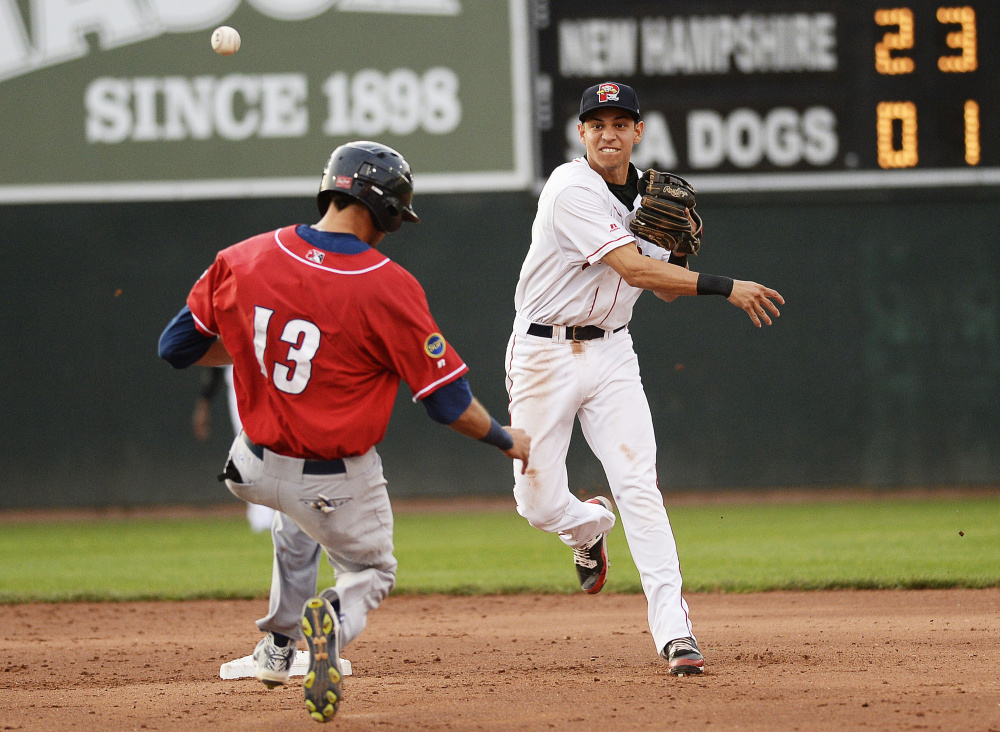 Shawn Patrick Ouellette/Staff Photographer
Mauricio Dubon of the Sea Dogs turns a double play as New Hampshire's Emilio Guerrero tries to break up the play at second in Wednesday night's game at Hadlock Field.