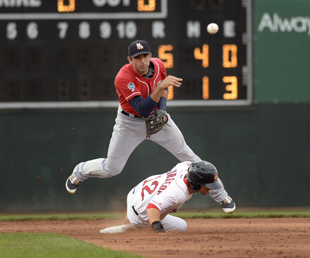 New Hampshire's Jason Leblebijian attempts to turn a double play as Cole Sturgeon of the Portland Sea Dogs slides into second base to break up the play during Wednesday's game at Hadlock Field. The Sea Dogs won, 10-7.