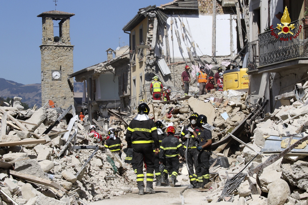 Rescuers work amid collapsed buildings in Amatrice, Italy, on Thursday. Rescue crews raced against time looking for survivors of the earthquake that leveled three towns in central Italy.