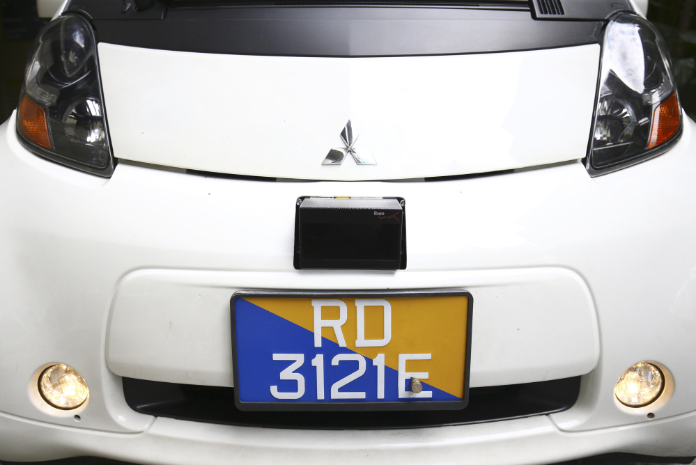 A Lidar, shown above the license plate of an autonomous vehicle in Singapore on Wednesday, detects obstacles using laser sensors. Each test car is fitted with six sets of the devices.