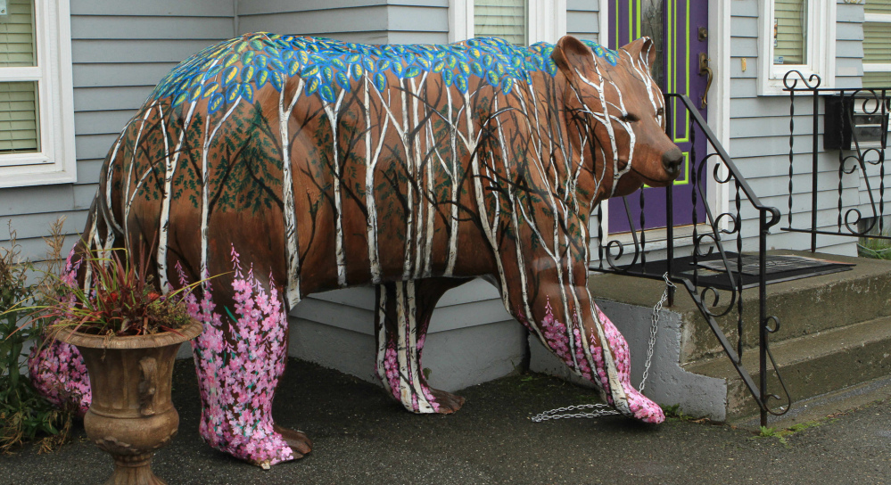 Birch forest and northern flora decorate the bear in front of All About You Medical Spa.