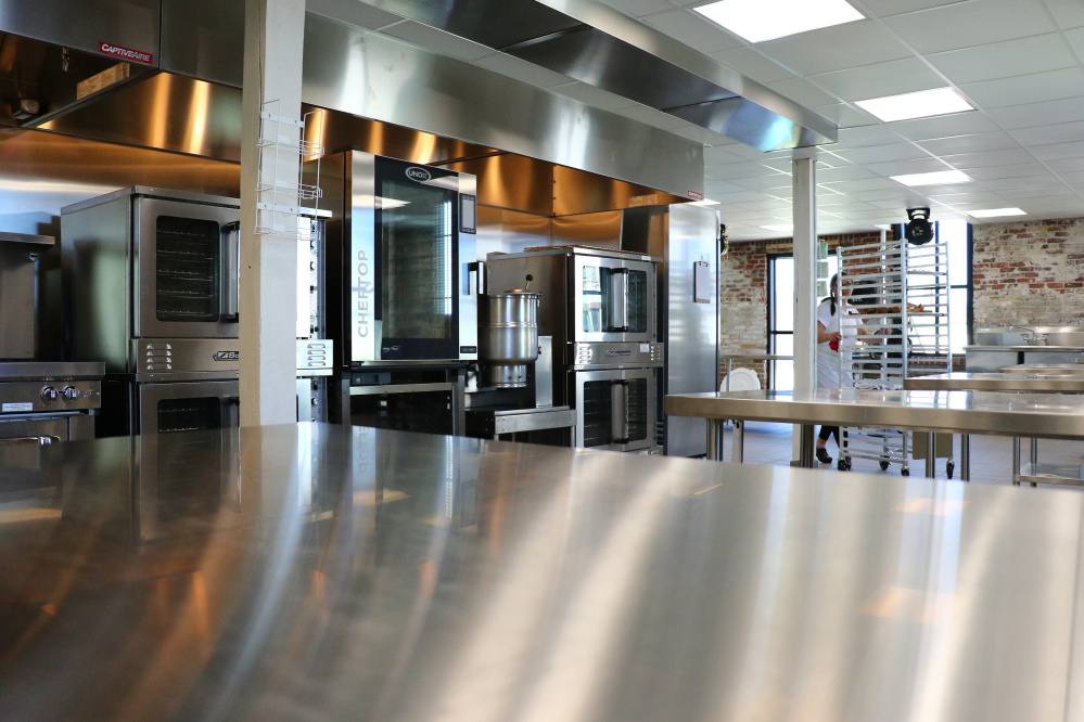 Christina Morrison of Have Chef Will Travel catering company works in the shiny new kitchen.