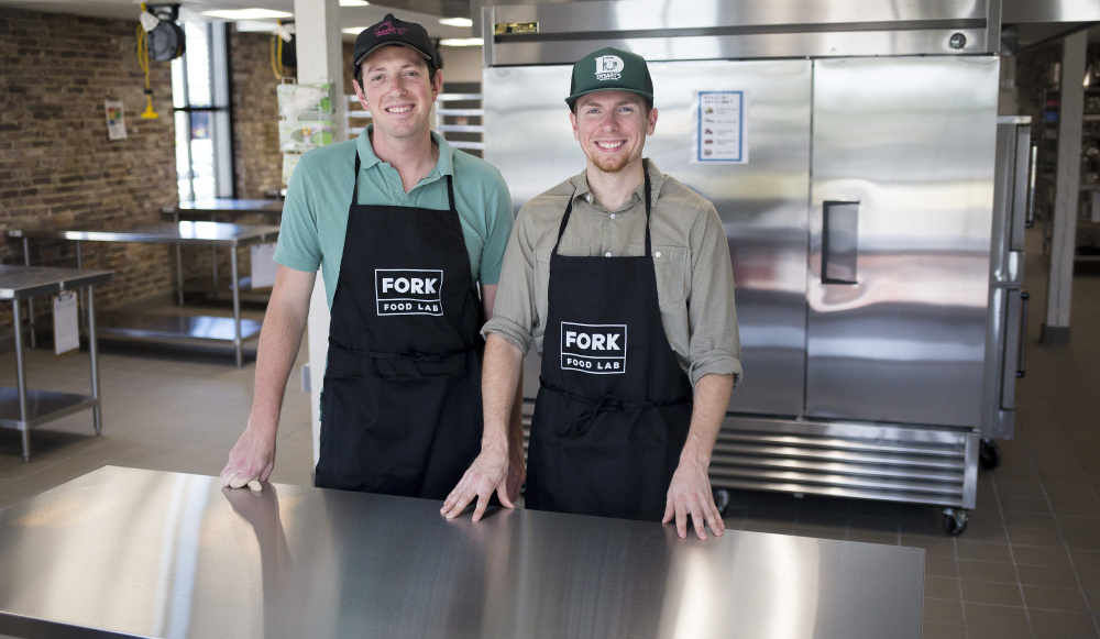 Co-owners of Fork Food Lab, from left, Eric Holstein and Neil Spillane stand in their new kitchen incubator in Portland's West Bayside.