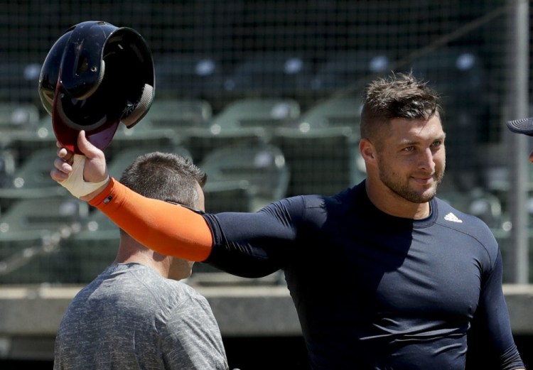 Former NFL quarterback Tim Tebow finishes his workout for baseball scouts and the media during a showcase Tuesday at USC in Los Angeles. The Heisman Trophy winner is trying baseball for the first time since high school.
