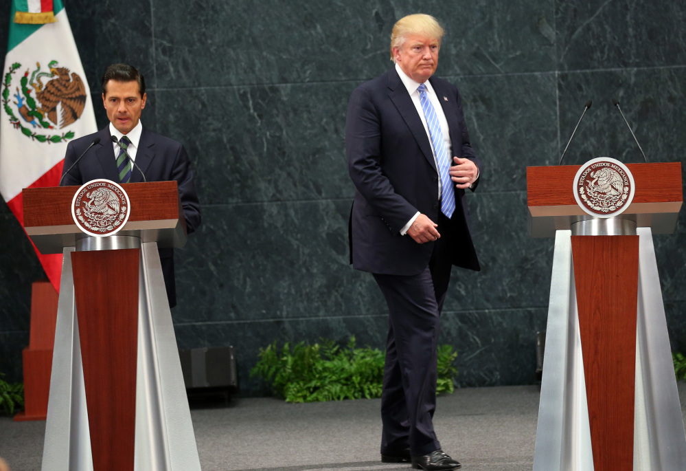 Donald Trump walks to take his place as Mexico's President Enrique Pena Nieto prepares to speak Wednesday during a joint statement at Los Pinos, the presidential official residence in Mexico City.