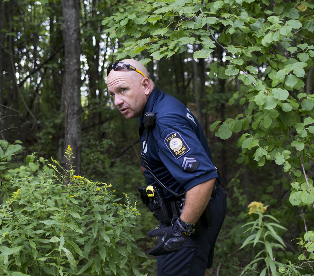 Portland officer Les Smith goes off trail into a homeless encampment to check if anyone is still living there. Some of the homeless people have been living on the land for years.