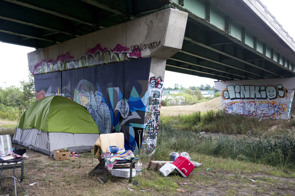 Most camp occupants appeared to be complying with the police order to leave, but some residents living under this Maine Turnpike overpass have said they don't plan to go anywhere.