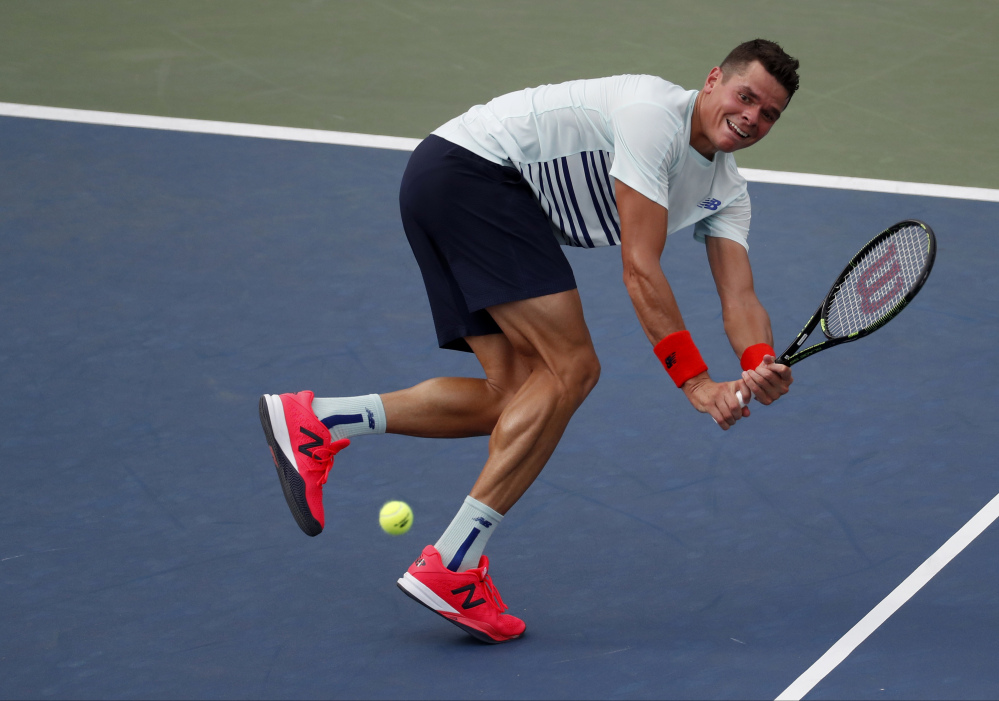 Milos Raonic returns a shot to Ryan Harrison in their second-round match Wednesday at the U.S. Open.