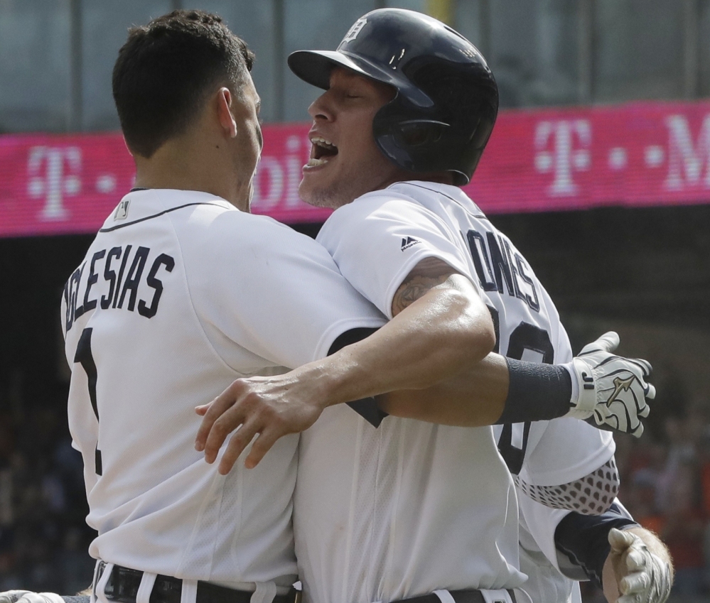 Detroit's JaCoby Jones, right, is greeted by teammate Jose Iglesias after scoring the winning run in a 3-2 victory over the White Sox at Chicago on Wednesday.