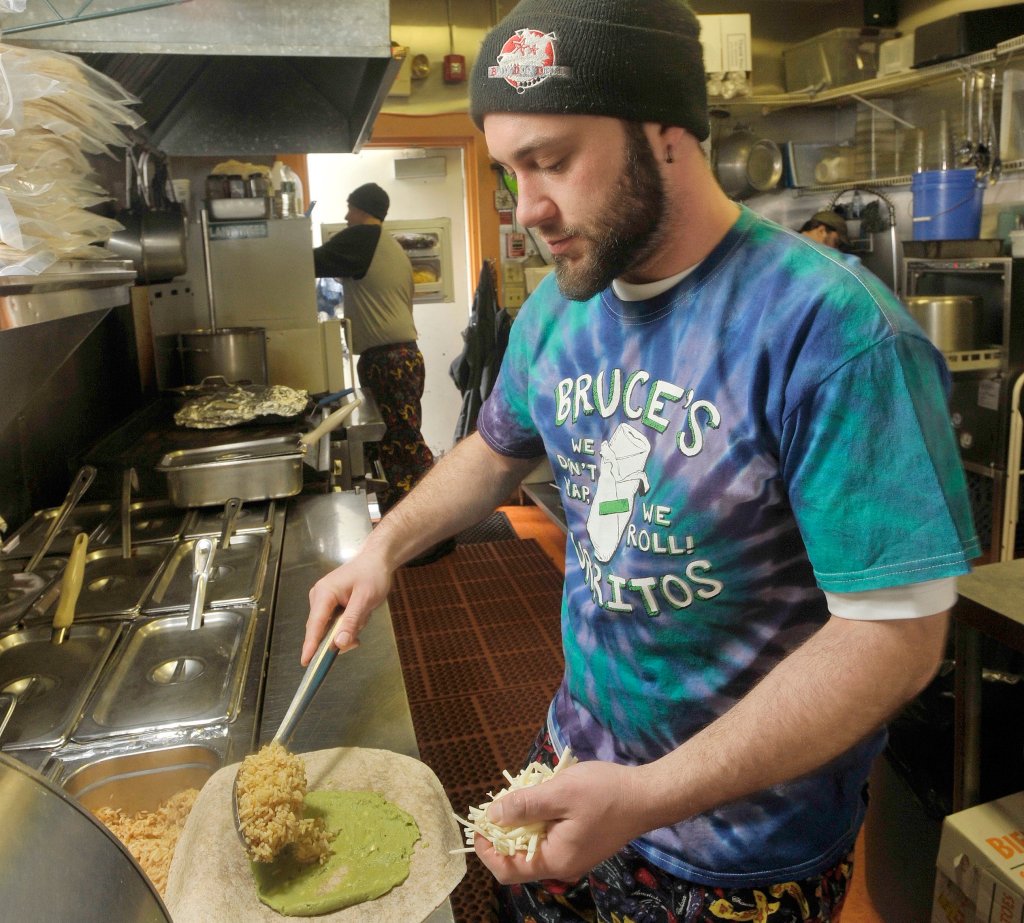 Christopher Hall begins preparing a burrito for a lunchtime customer at Bruce's Burritos in Yarmouth in this March 11, 2014 file photograph.