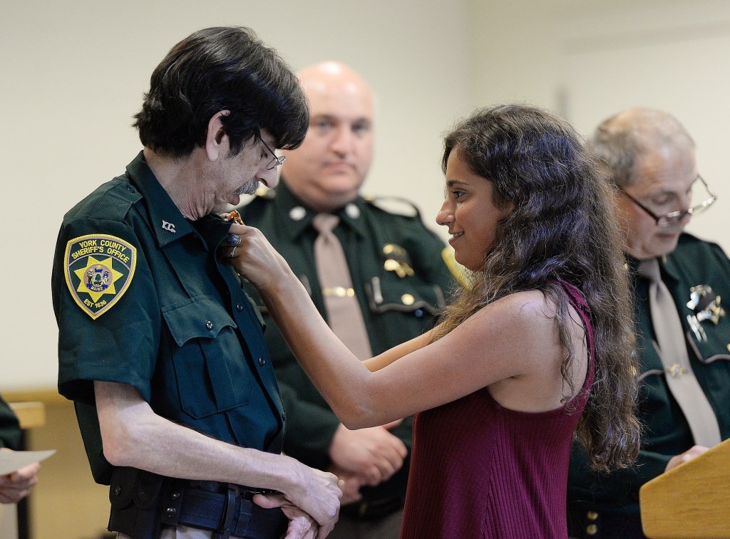 Jon Simonds of North Waterboro has his daughter Kaitlyn pin his new badge on his uniform at the York County Jail on Friday. Simonds, 60, said the job as a corrections officer is the first he’s had in a decade that offered benefits.
Shawn Patrick Ouellette/Staff Photographer