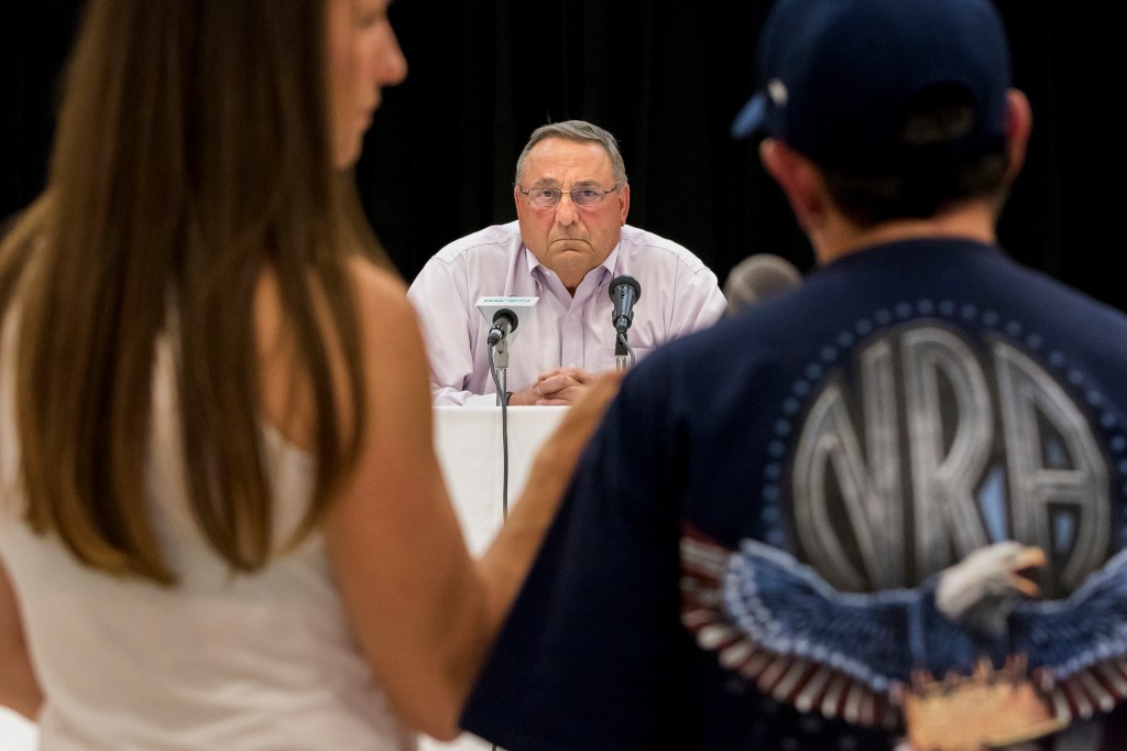 Gov. Paul LePage listens to a question about heroin addiction from Sanford resident Marge Trowbridge, right, during a town hall-style meeting at Sanford High School. LePage's press secretary, Adrienne Bennett is at left. (Photo by Ben McCanna/Staff Photographer)