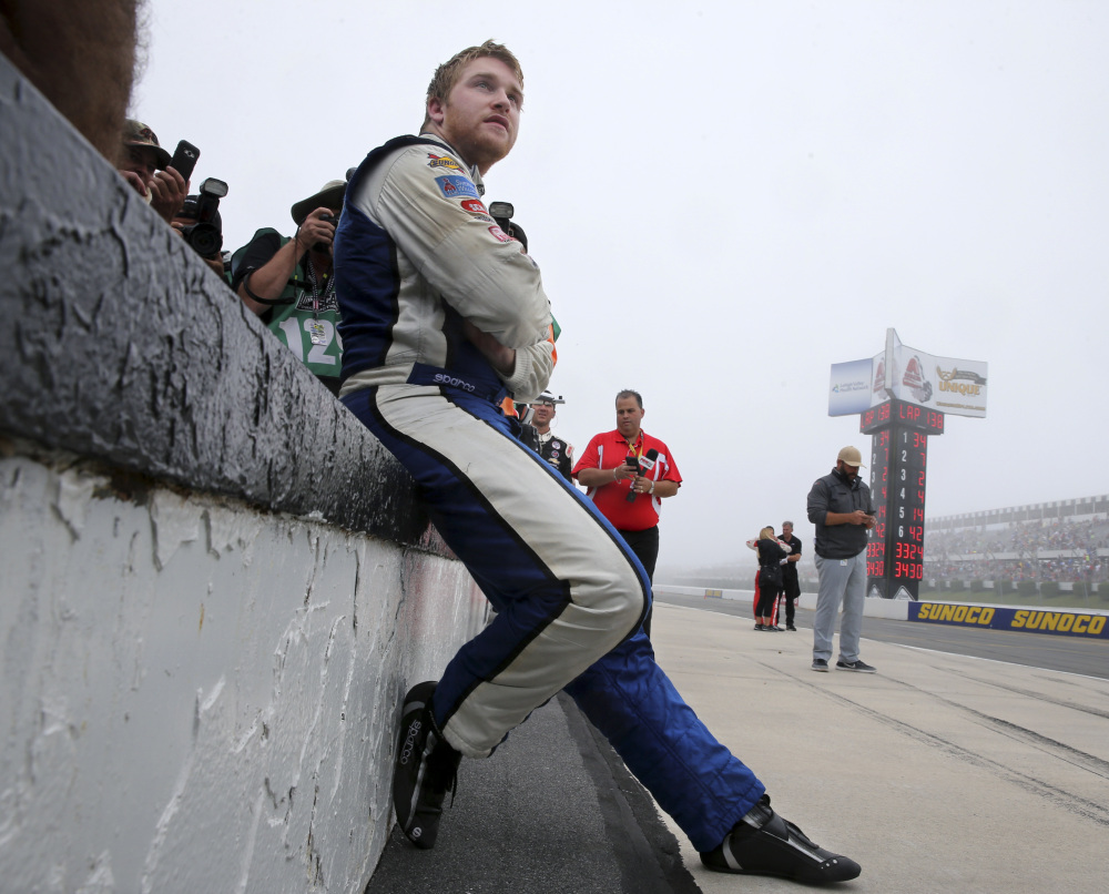 Chris Buescher sits on a pit wall waiting to be declared the winner of the rain-shortened Pennsylvania 400 at Pocono Raceway in Long Pond, Pa., on Monday.