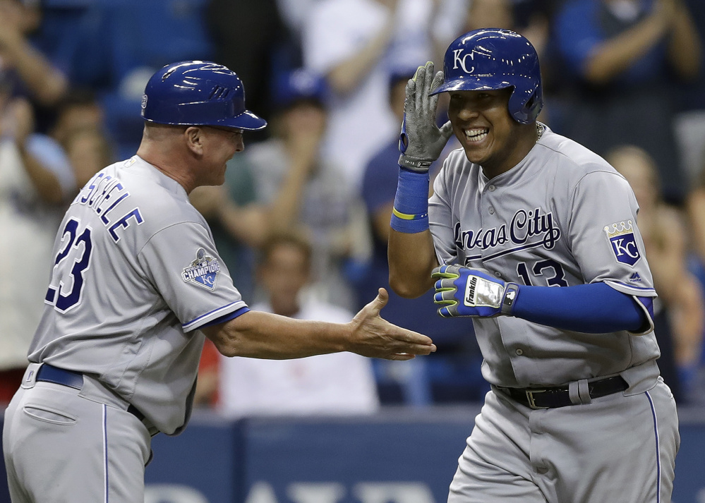 Salvador Perez, right, celebrates with third base coach Mike Jirschele after hitting a go-ahead two-run homer in the seventh inning against Tampa Bay on Tuesday in St. Petersburg, Fla.