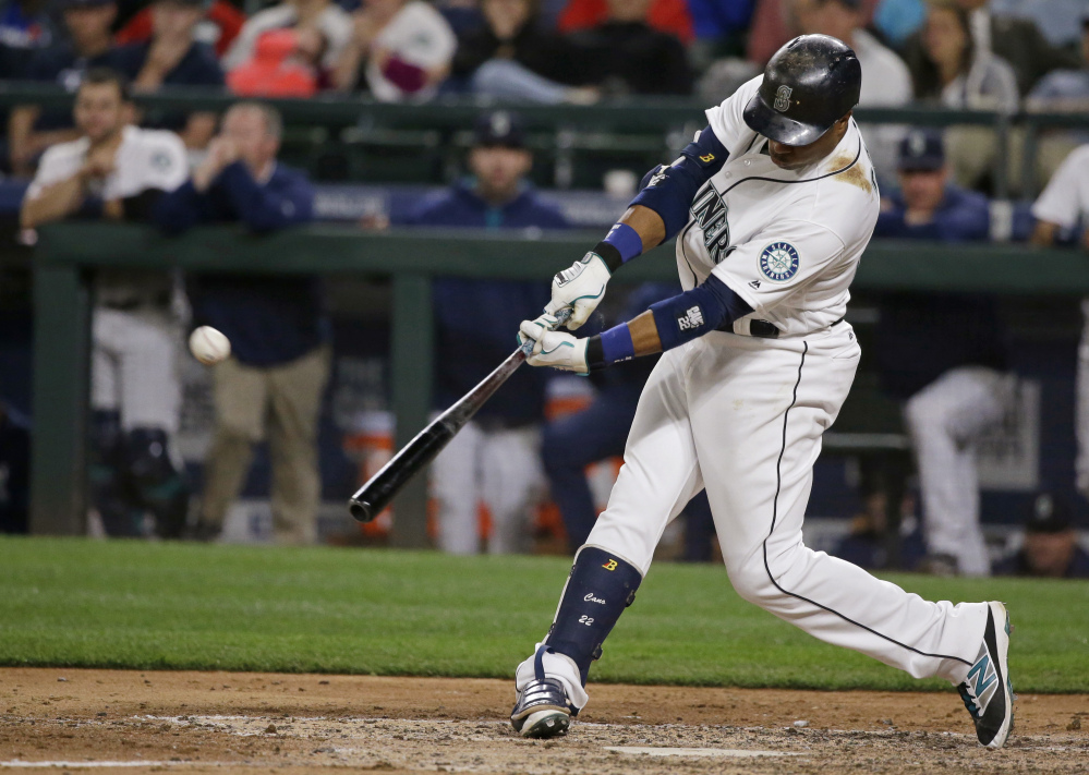 The Mariners' Robinson Cano hits the game-winning three-run homer against Red Sox reliever Fernando Abad in the eighth inning.