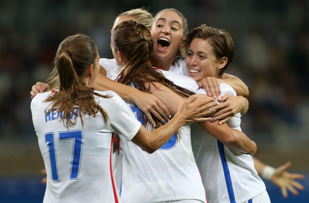 United States players celebrate Wednesday after Alex Morgan scored a second-half goal that finished off a 2-0 victory against New Zealand in an Olympic opener.