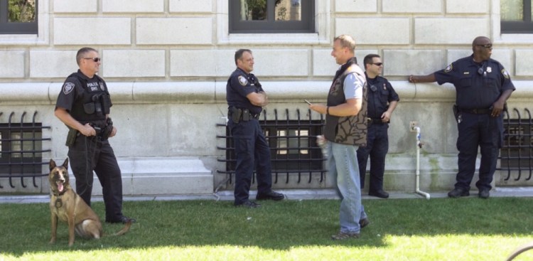 Five Department of Homeland Security officers stand guard in front of the Edward T. Gignoux U.S. Courthouse in Portland while Espen Brungodt made an initial appearance Thursday in U.S. District Court. Brungodt is facing a felony charge of sending threatening interstate communications.