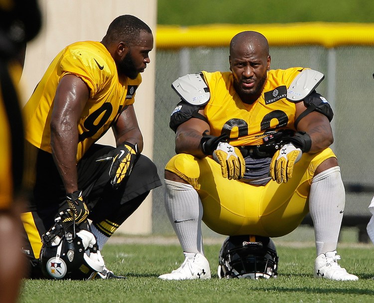 Pittsburgh Steelers linebackers James Harrison, right, and Vince Williams take a break during a practice at the NFL football team's training camp in Latrobe, Pa. Harrison is one of four players the NFL has threatened to suspend for failing to cooperate with a PED investigation. Associated Press/Gene J. Puskar